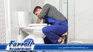 Professional Plumber Fixing a Toilet Bowl