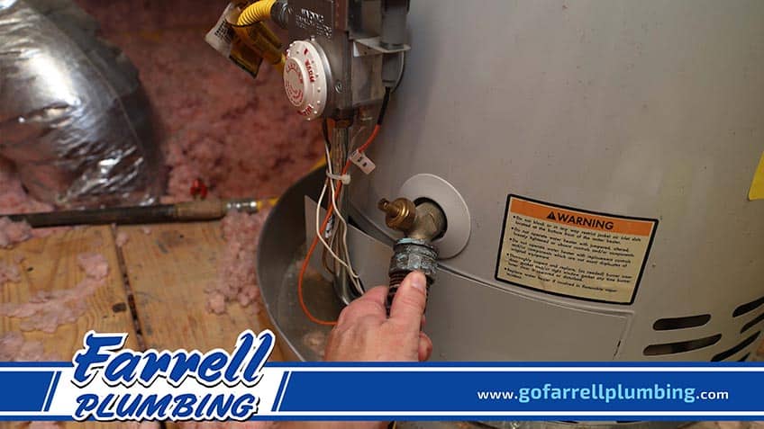 Plumber Conducting Water Heater Maintenance