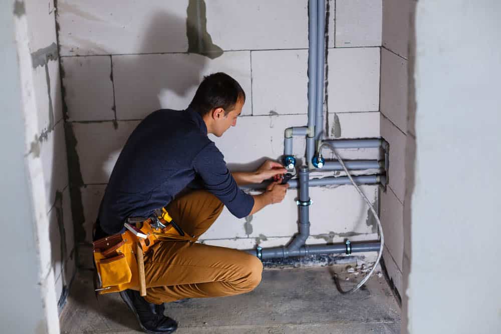 plumber makes wiring of sewer pipes