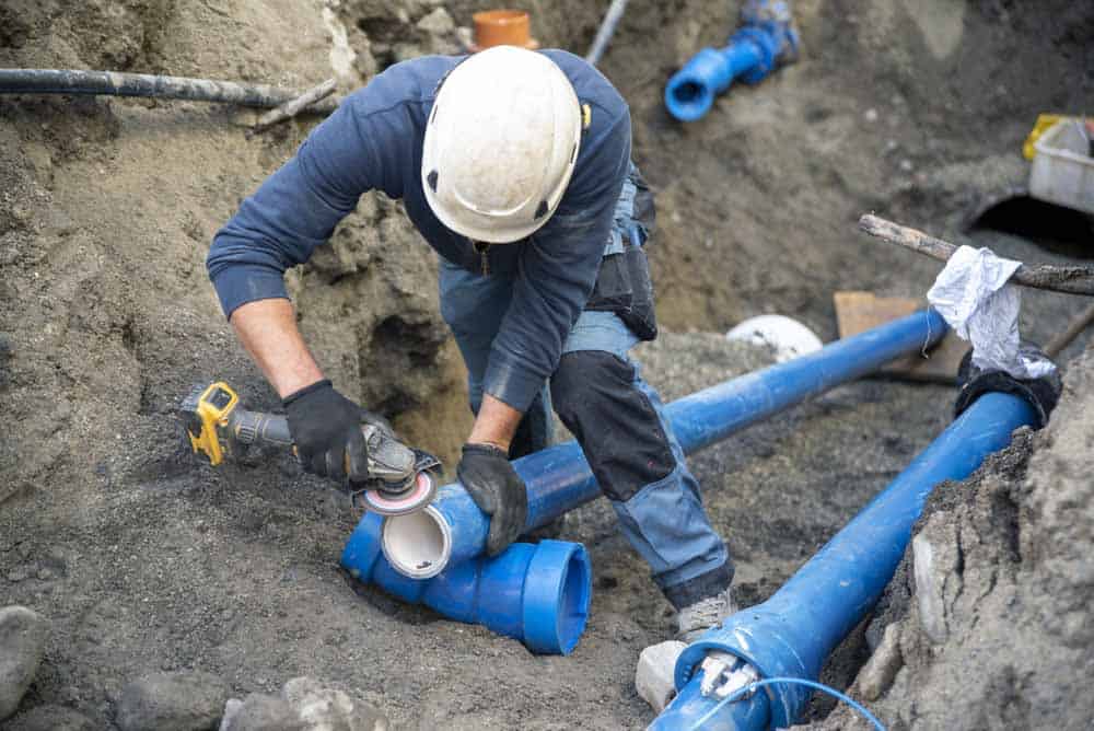 technicians replacing sewer line pipes