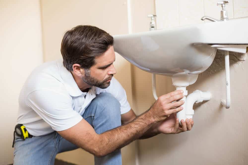 plumber installing a plumbing fixture