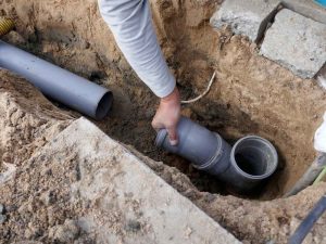 technicians replacing sewer line pipes